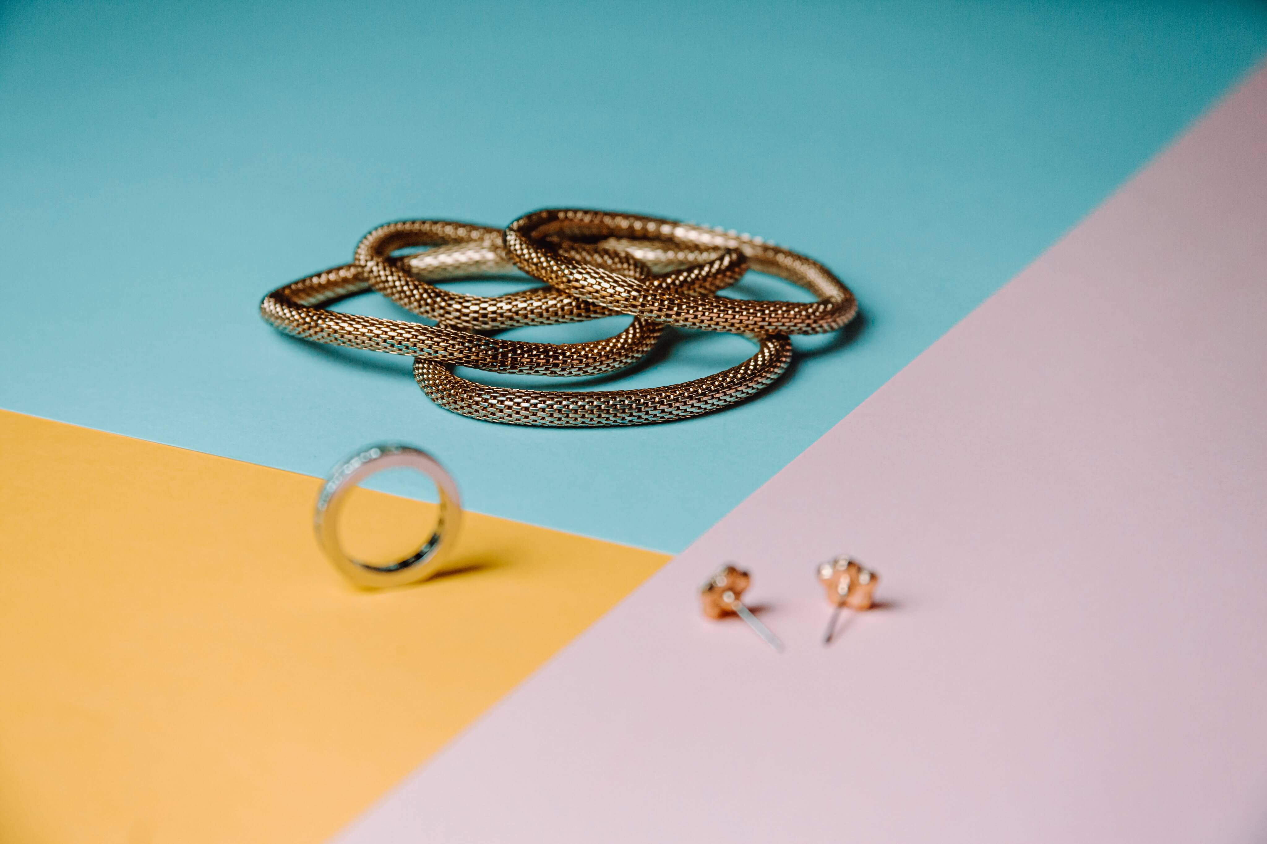 colorful-background-with-gold-jewelry-displayed-on-it